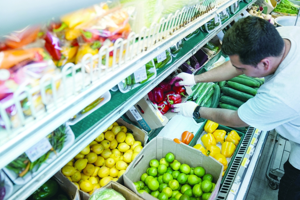 A man arranges produce at Best World Supermarket in the Mount Pleasant neighborhood of Washington, DC. — Reuters