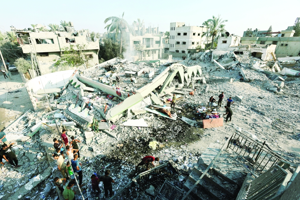 Palestinians inspect a destroyed mosque amid Israel-Hamas conflict in Deir Al Balah in the central Gaza Strip. — Reuters