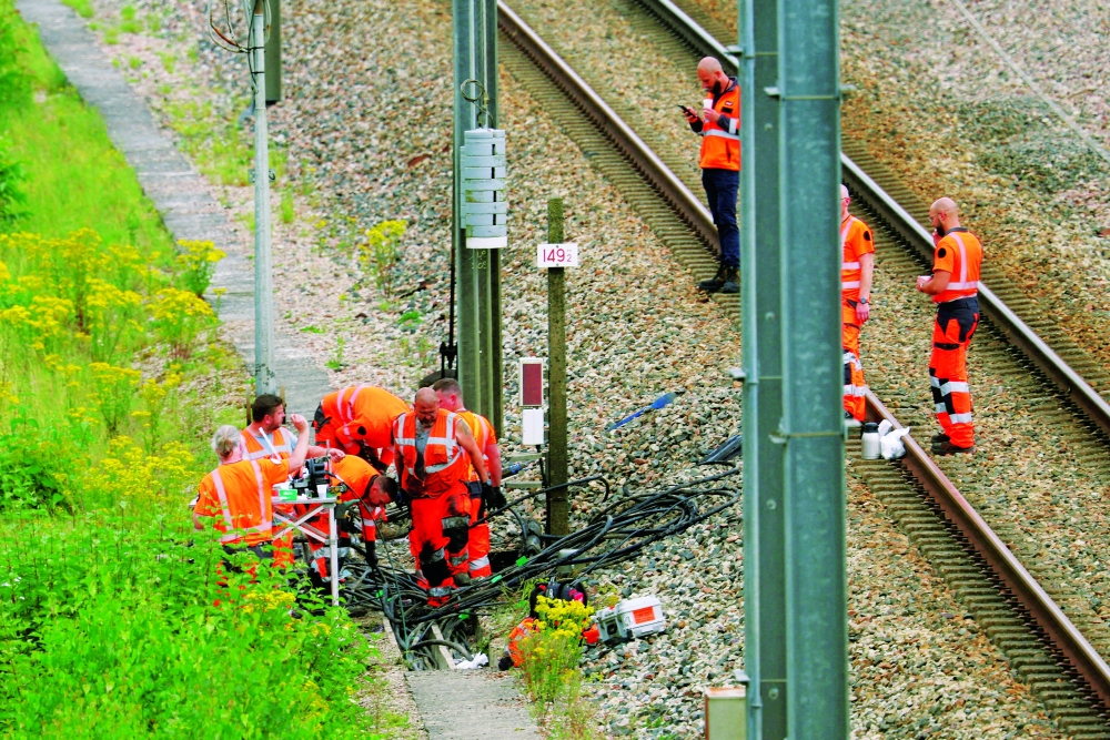SNCF railway workers and law enforcement officers work at the site where vandals targeted France's high-speed train network with a series of coordinated actions that brought major disruption in Croisilles, northern France. — Reuters