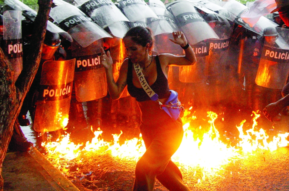 A demonstrator reacts when Molotov cocktails hit the ground in front of security forces during protests against election results after Venezuela's President Nicolas Maduro and his opposition rival Edmundo Gonzalez claimed victory in Sunday's presidential election, in Puerto La Cruz on Tuesday. — Reuters