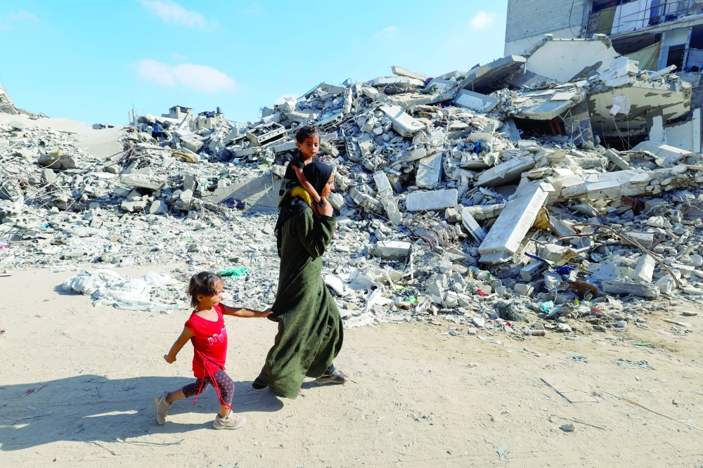 Palestinians make their way to return to neighbourhoods after Israeli forces pulled out from the eastern side of Khan Younis on Tuesday. — Reuters