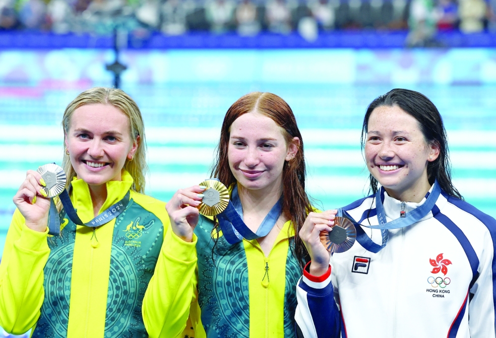 Gold medallist Mollie O'Callaghan celebrates with silver medallist Ariarne Titmus and bronze medallist Siobhan Bernadette Haughey. — Reuters
