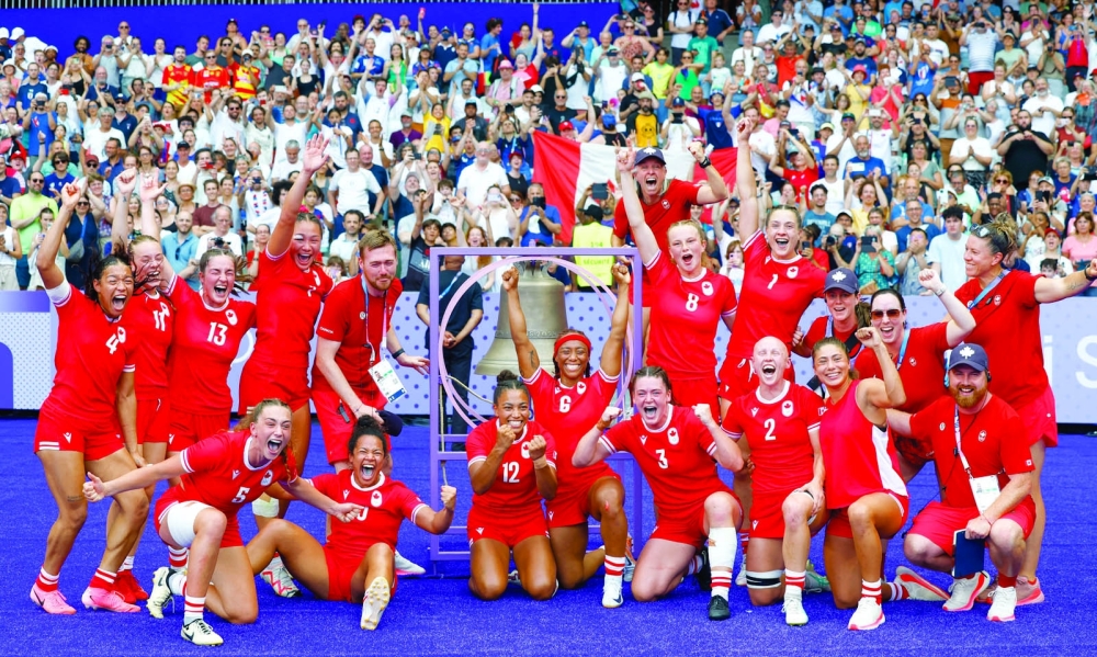 Team Canada celebrate after the match. — REUTERS