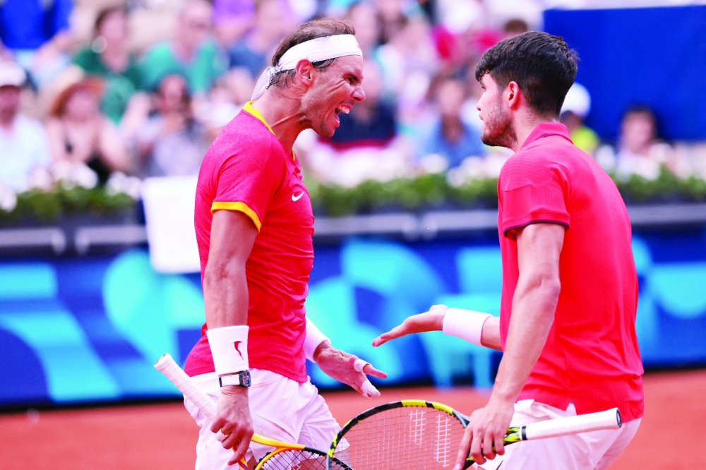 Carlos Alcaraz and Rafael Nadal react during the match. — Reuters
