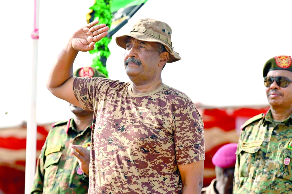 Sudan's army chief Abdel Fattah al Burhan salutes during a graduation ceremony in Gibet near Port Sudan on Wednesday. — AFP