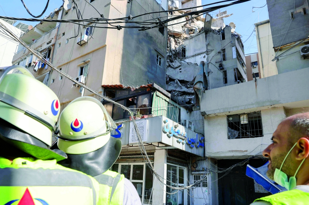 Lebanese security forces check the area in the aftermath of an Israeli military strike on a building in Beirut's southern suburb on Wednesday. — AFP