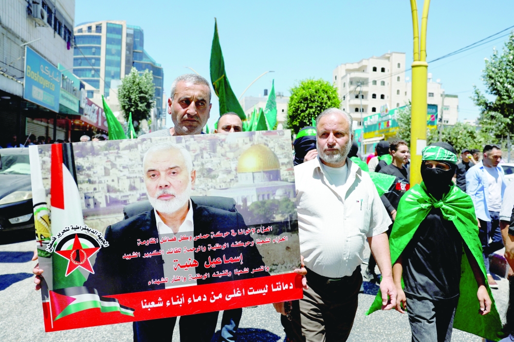Palestinians protest after the assassination of Hamas leader Ismail Haniyeh in Hebron on Wednesday. — Reuters