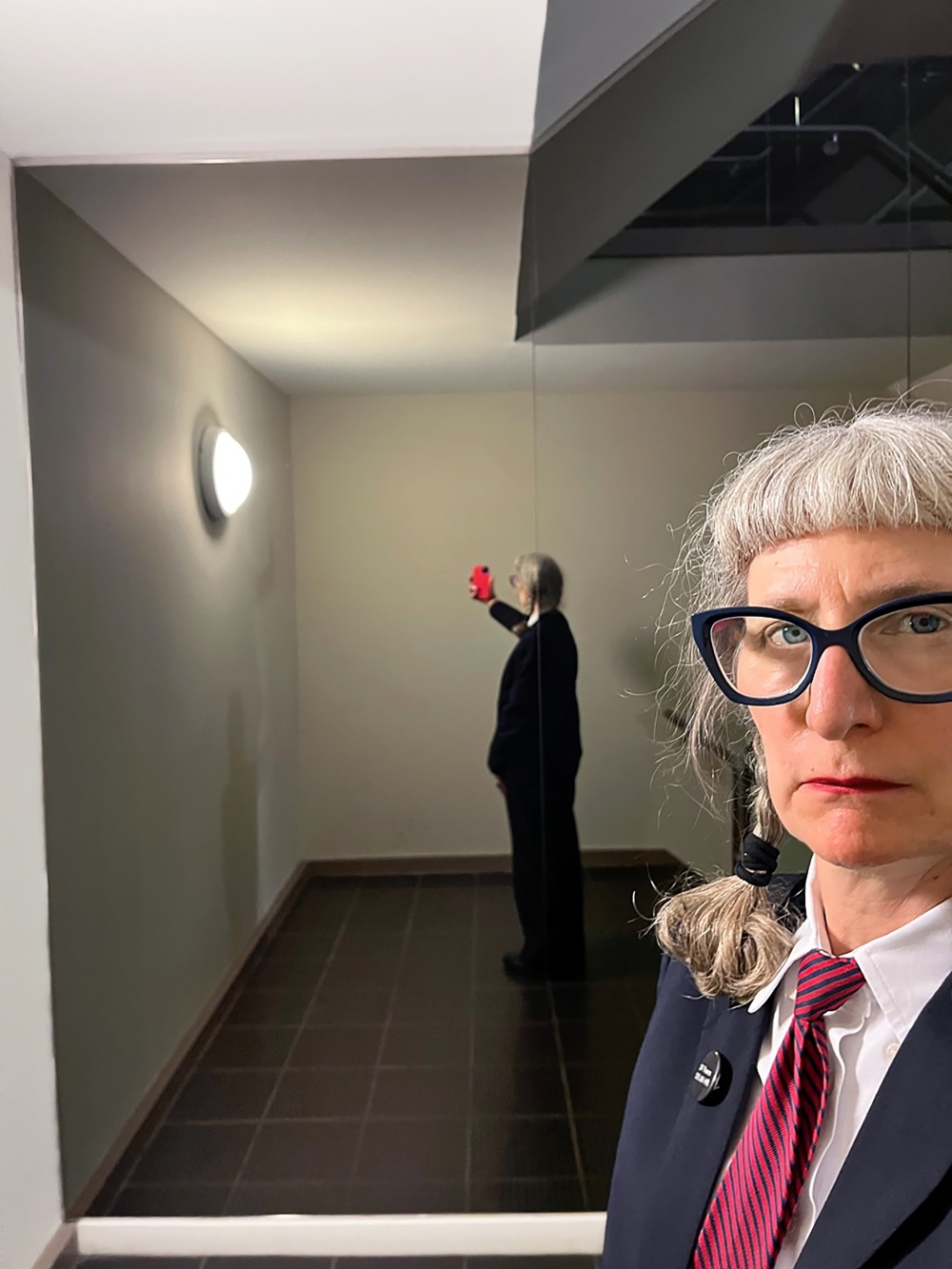 Emilie Lemakis, 58, who has been a security guard at the Metropolitan Museum of Art in New York for 29 years, wears a pin that shows how many years she has worked there and her hourly wage. (Emilie Lemakis via The New York Times)