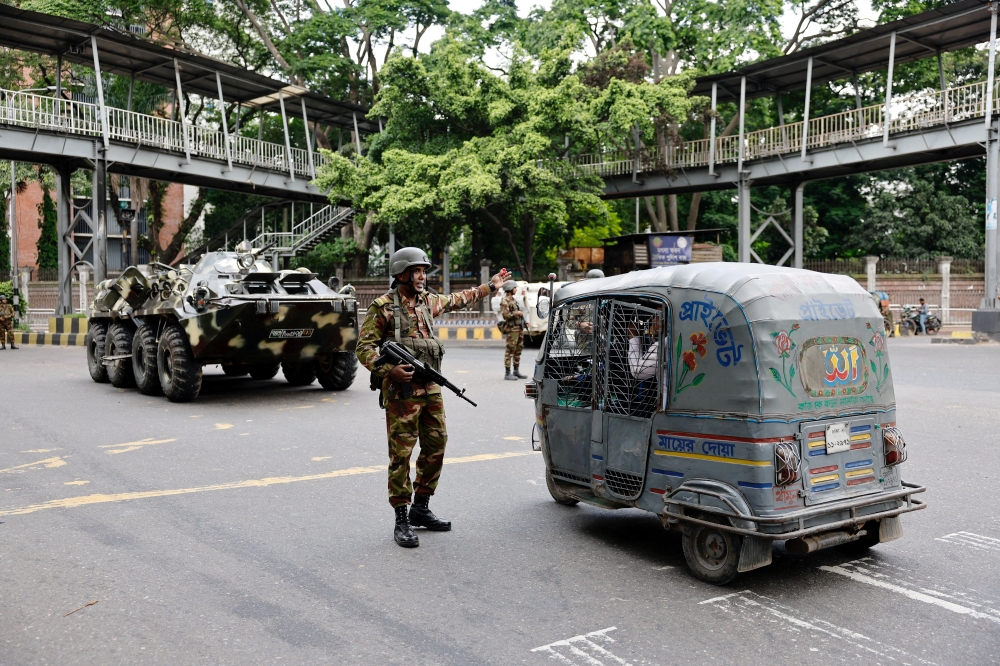 Members of the Bangladesh Army are seen on duty on the second day of curfew