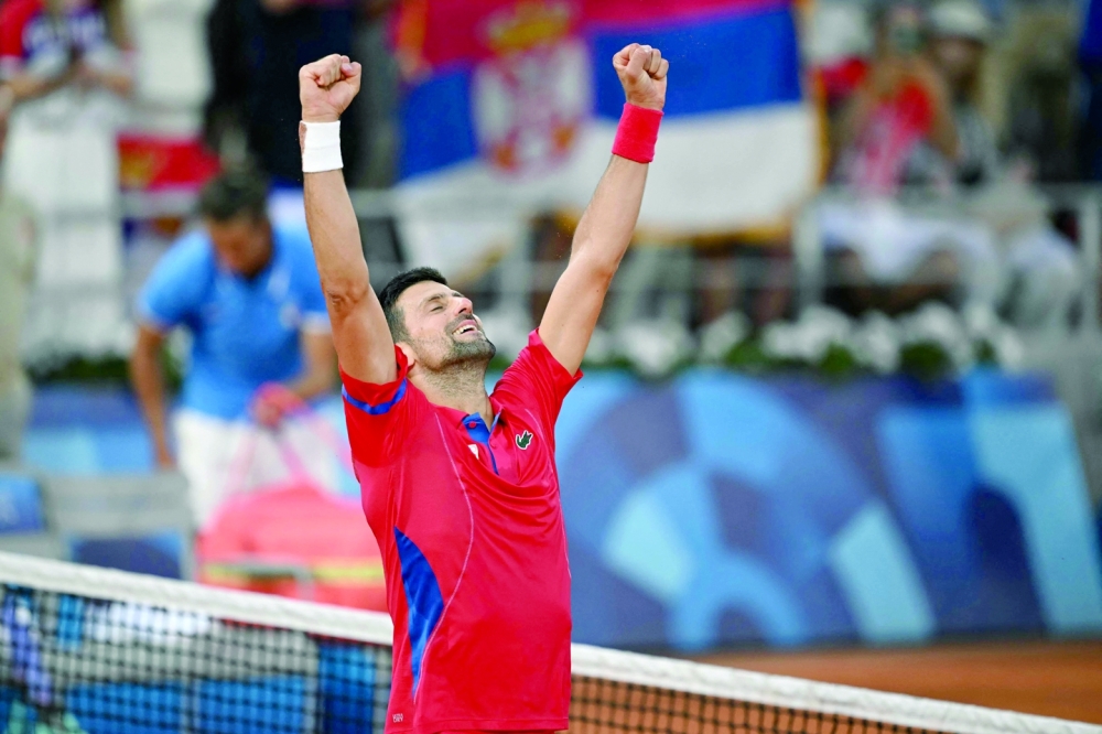 Djokovic celebrates beating Italy's Lorenzo Musetti during their men's singles semi-final tennis match on Court Philippe-Chatrier at the Roland-Garros Stadium during the Paris 2024 Olympic Games.