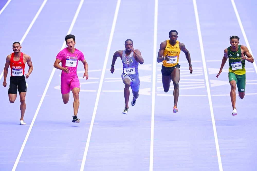 Oman's Ali Anwar Ali Al Balushi, China's Xie Zhenye, US' Noah Lyles, Germany's Owen Ansah and South Africa's Shaun Maswanganyi compete in the men's 100m heat of the athletics event at the Paris 2024 Olympic Games at Stade de France in Saint-Denis, north of Paris. - AFP