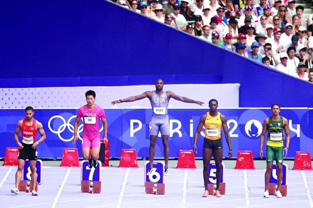 Oman's Ali Anwar Ali Al Balushi, China's Xie Zhenye, US' Noah Lyles, Germany's Owen Ansah and South Africa's Shaun Maswanganyi prepare to take the start in the men's 100m heat of the athletics event at the Paris 2024 Olympic Games at Stade de France in Saint-Denis, north of Paris. -