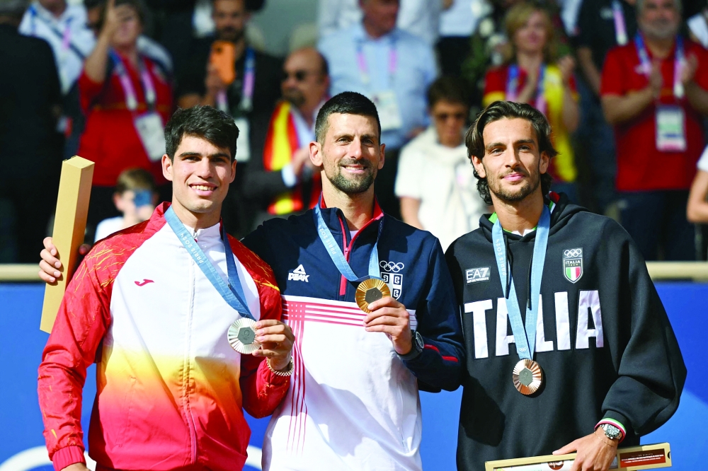 (L-R) Carlos Alcaraz, Novak Djokovic and Lorenzo Musetti pose with their medals. — AFP