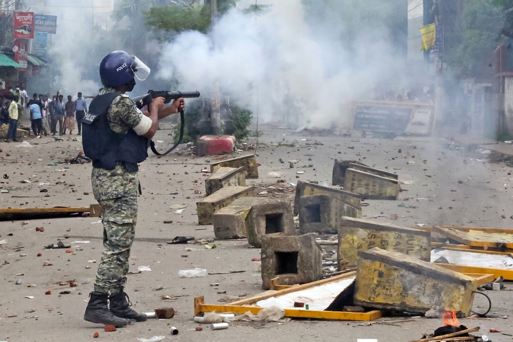 Police use tear gas to disperse student protestors in Bogura on August 4, 2024. (Photo by AFP)

