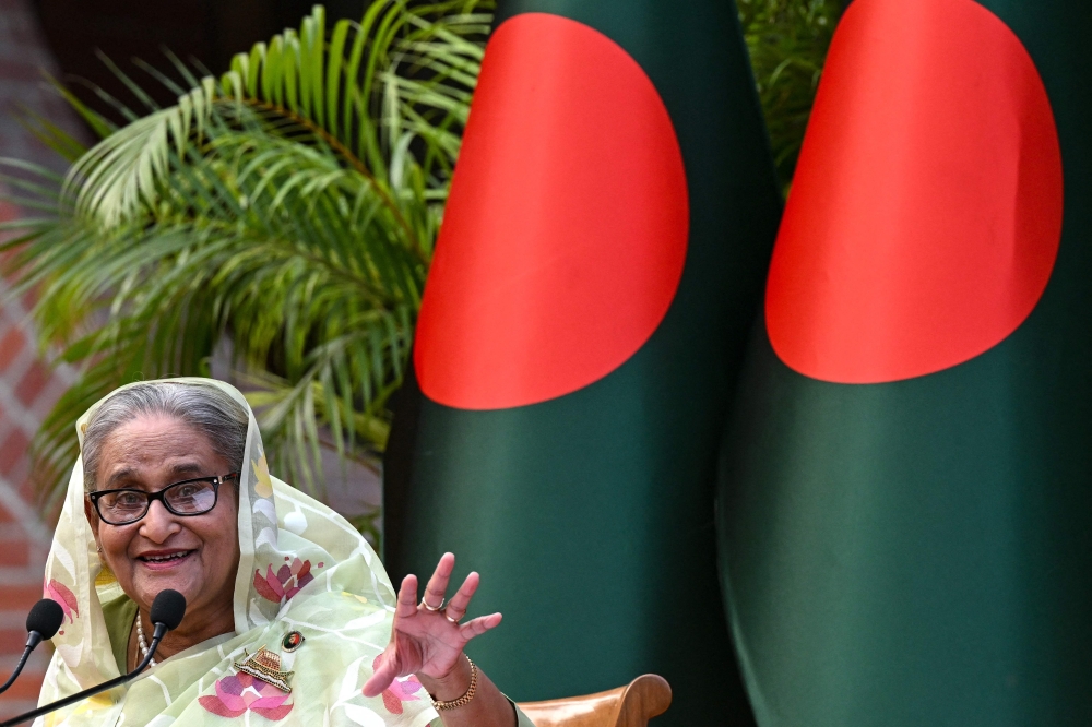 Bangladesh's Prime Minister Sheikh Hasina gestures while speaking to the media in January
