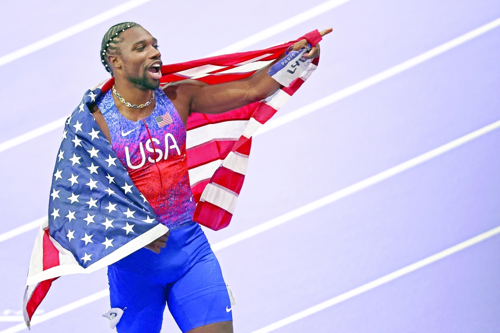 US' Noah Lyles celebrates after winning the men's 100m final of the athletics event at the Paris 2024 Olympic Games at Stade de France in Saint-Denis, north of Paris, on August 4, 2024.