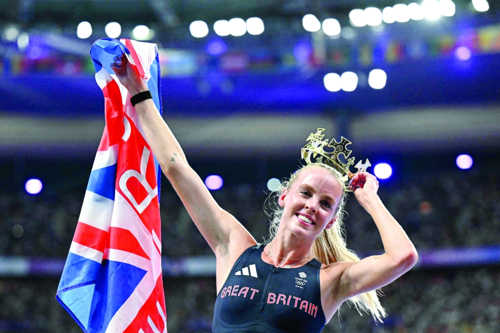 Britain's Keely Hodgkinson celebrates after winning the women's 800m final of the athletics event at the Paris 2024 Olympic Games at Stade de France in Saint-Denis, north of Paris, on August 5, 2024. 