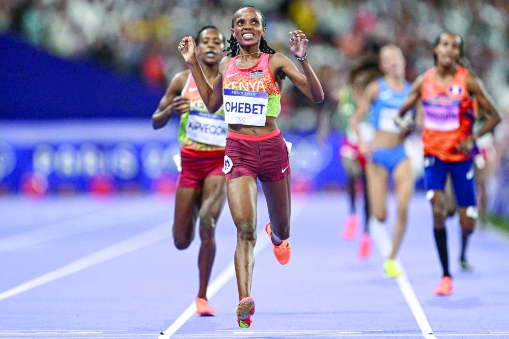 Kenya's Beatrice Chebet crosses the finish line to win in the women's 5000m final of the athletics event at the Paris 2024 Olympic Games at Stade de France in Saint-Denis, north of Paris, on August 5, 2024.