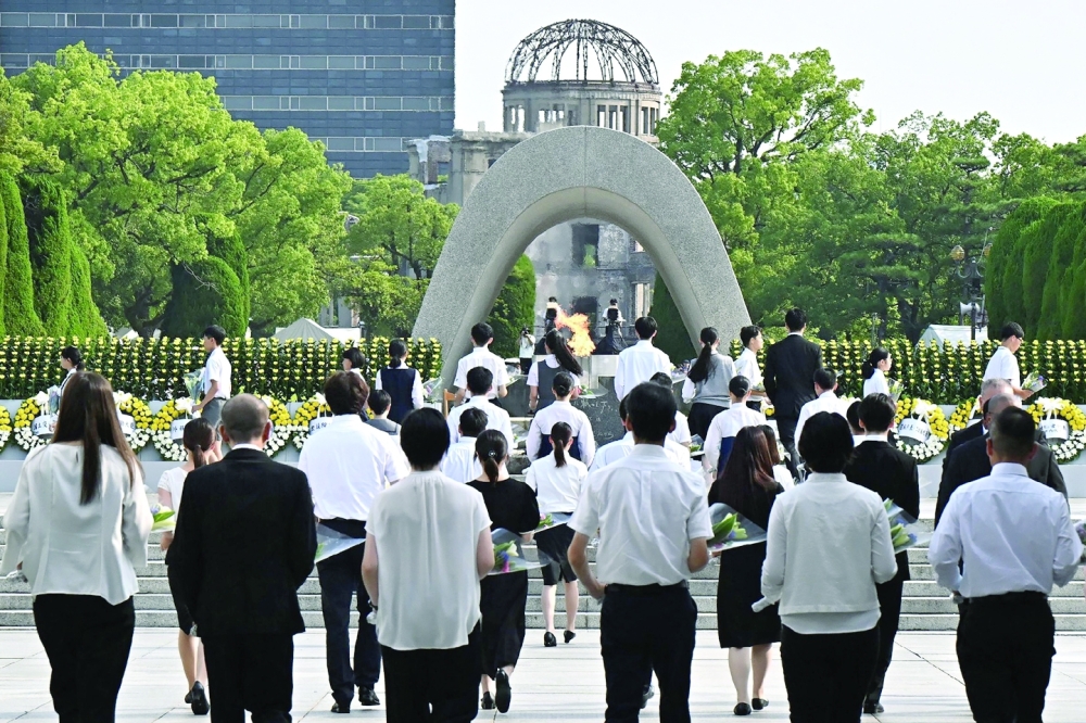 Representatives lay flowers at the Peace Memorial Ceremony held at the Peace Memorial Park in Hiroshima. — AFP 
