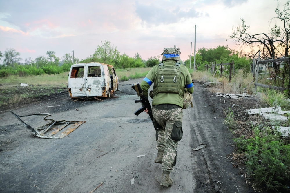 A Ukrainian serviceman runs on the street at a front line, near the town of Chasiv Yar in Donetsk region, Ukraine. — Reuters 