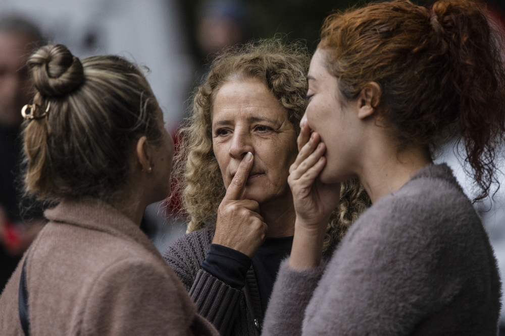 Residents gather near the scene of a passenger plane crash in the Capela neighborhood of Vinhedo, Brazil, Aug. 9, 2024. (Victor Moriyama/The New York Times)