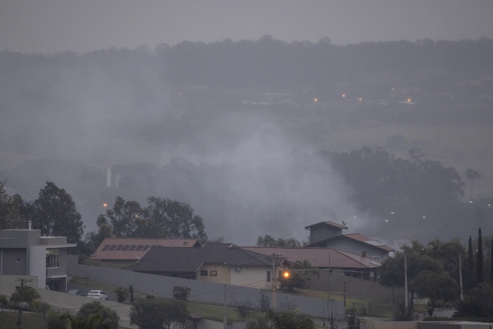 Smoke rises from the scene of a passenger plane crash in the Capela neighborhood of Vinhedo, Brazil, Aug. 9, 2024. (Victor Moriyama/The New York Times)