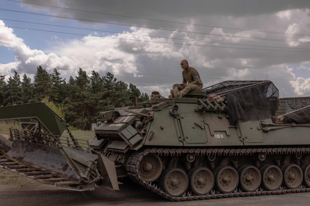 Ukrainian servicemen operate an armoured military vehicle in the Sumy region, near the border with Russia. — AFP 