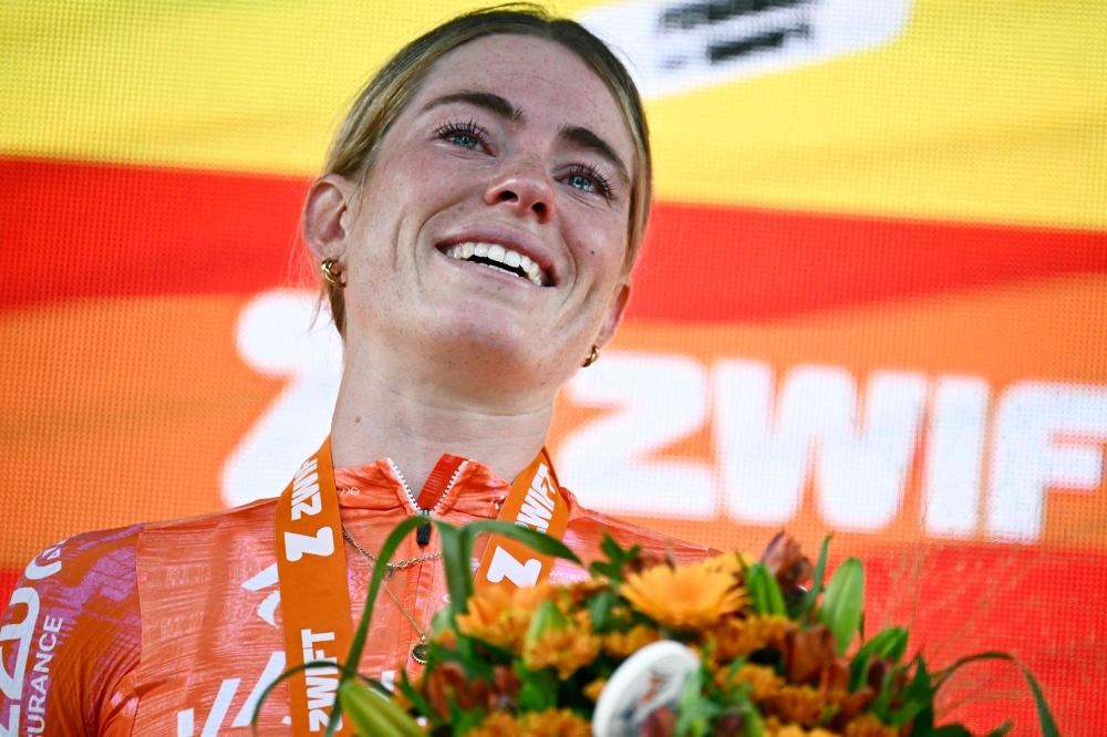 Team SD Worx - Protime's Dutch rider Demi Vollering celebrates on the podium after winning the 3rd stage (out of 8) of the third edition of the Women's Tour de France cycling race a 6,3 km individual time trial between Rotterdam and Rotterdam, on August 13, 2024.
  (Photo by JULIEN DE ROSA / AFP)

