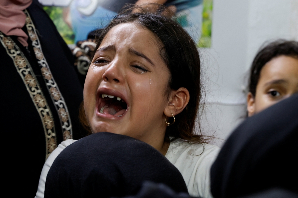 A girl reacts during a farewell for Palestinian Ahmed Khalil killed in an Israeli airstrike, at his home, in the Balata refugee camp, in Nablus in the Israeli-occupied West Bank. - Reuters
