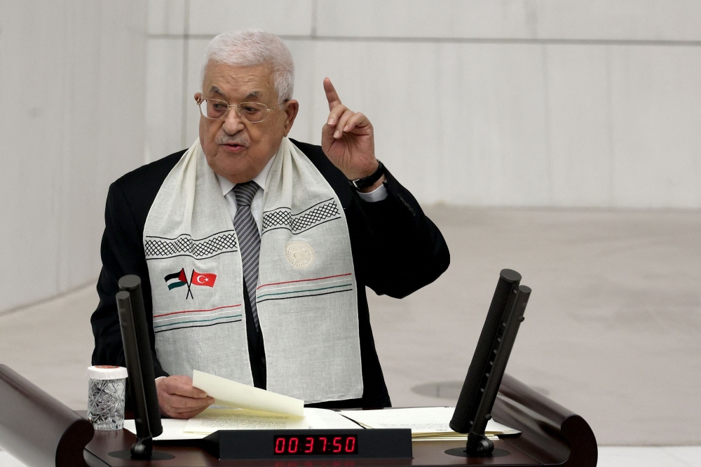 Palestinian Authority President Mahmud Abbas gestures as he gives a speech to Turkish MPs at Grand National Assembly of Turkey in Ankara on August 15, 2024. Palestinian Authority president Mahmud Abbas met with Turkey's President Recep Tayyip Erdogan on August 14, 2024 in Ankara for talks on a ceasefire and peace. (Photo by Adem ALTAN / AFP)