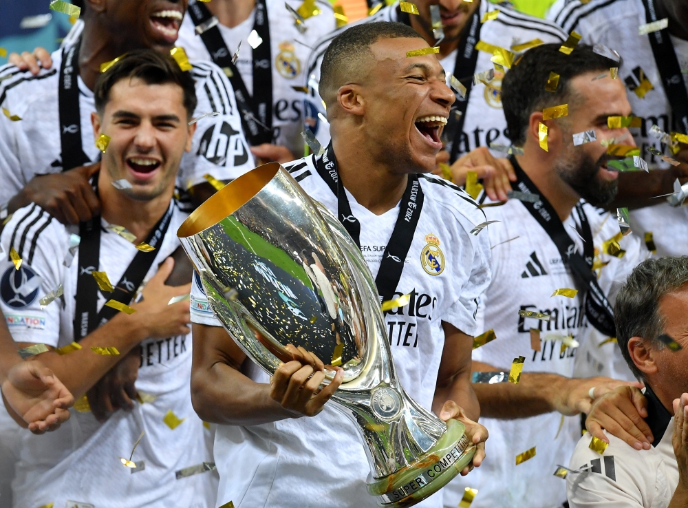 Real Madrid's Kylian Mbappe celebrates with the trophy after winning the Super Cup.— Reuters
