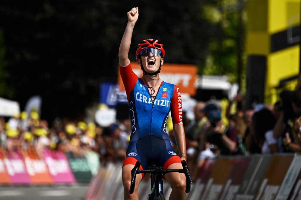 French rider Cedrine Kerbaol celebrates as she crosses the finish line to win the 6th stage (out of 8) of the third edition of the Women's Tour de France cycling race