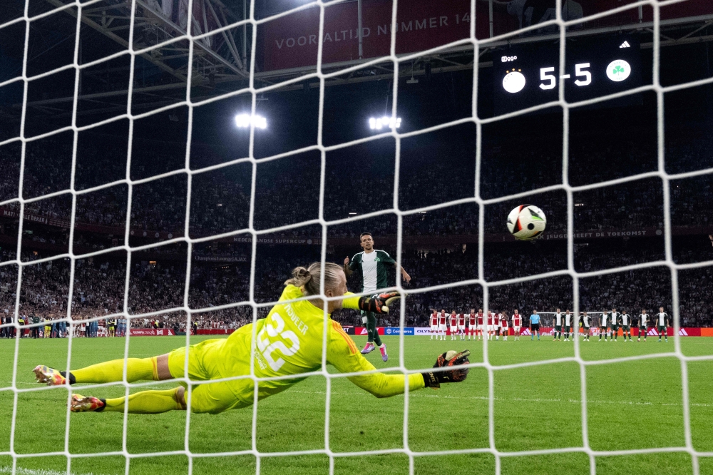 Dutch goalkeeper #22 Remko Pasveer (C) saves a penalty during the penalty shootout at the end of the UEFA Europa League 3rd Qualifying Round 