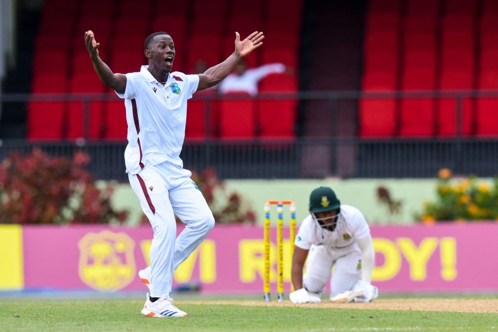 Shamar Joseph (L) of West Indies celebrates the dismissal of Temba Bavuma (R) of South Africa during Day 1 of the 2nd Test match