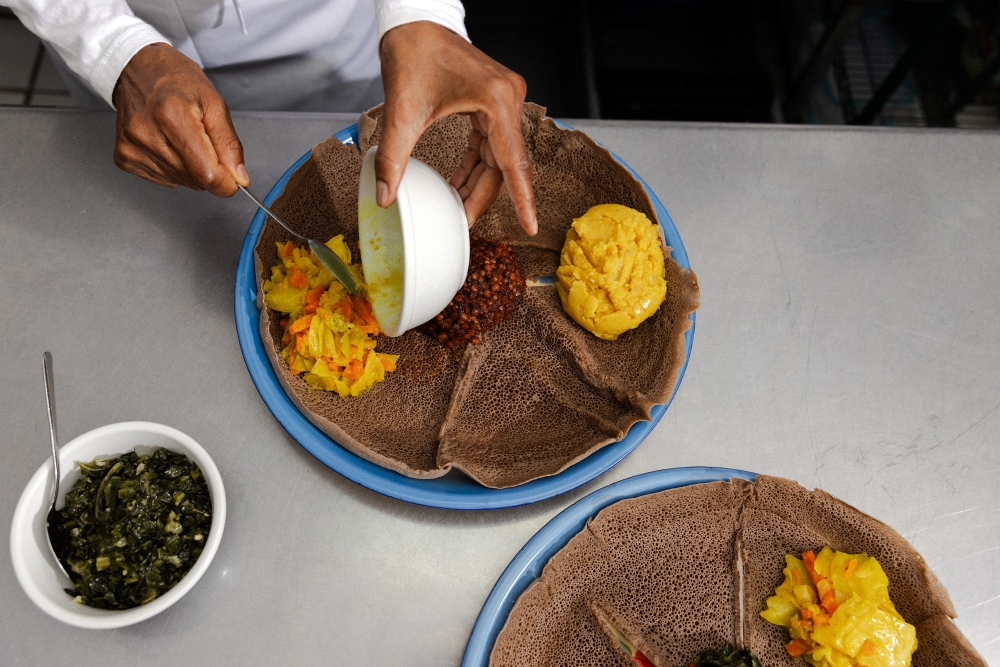 Genet Agonafer, chef and owner of Meals by Genet, prepares a dish at her restaurant in Los Angeles