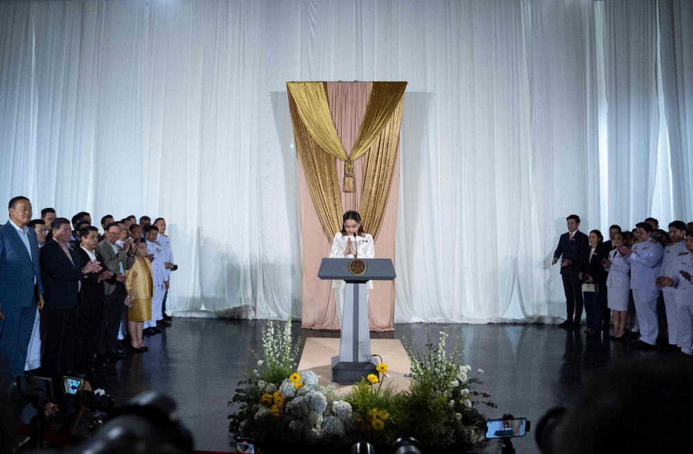 Thai Prime Minister Paetongtarn Shinawatra greets members of the media during a press conference 