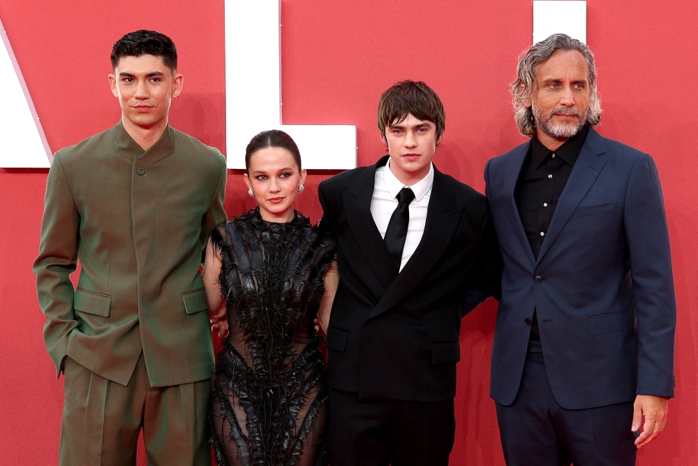 English actor Archie Renaux, US actor Cailee Spaeny, English actor Spike Fearn and Uruguayan director Fede Alvarez pose on the red carpet upon arrival to attend the UK gala event