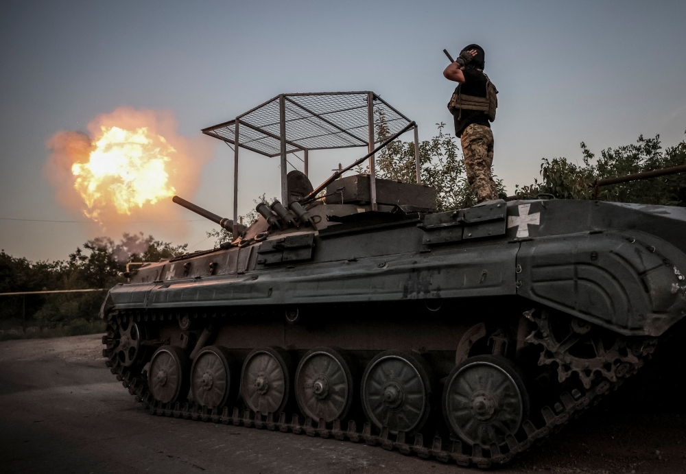 Servicemen fire towards Russian troops at a front line, near the town of Chasiv Yar in Donetsk region, Ukraine