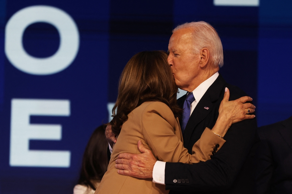 U.S. President Joe Biden and Democratic presidential candidate and U.S. Vice President Kamala Harris embrace during Day one of the Democratic National Convention (DNC) in Chicago