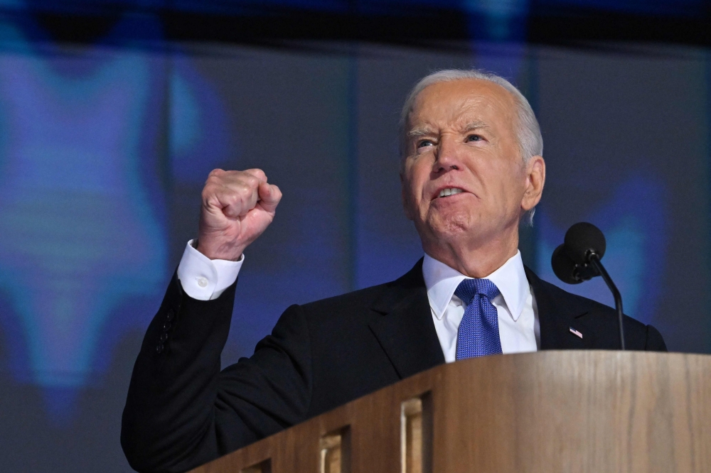 US President Joe Biden speaks on stage on the first day of the Democratic National Convention (DNC) at the United Center in Chicago, Illinois, on August 19, 2024. Vice President Kamala Harris will formally accept the party痴 nomination for president at the DNC which runs from August 19-22 in Chicago. (Photo by Robyn Beck / AFP)
