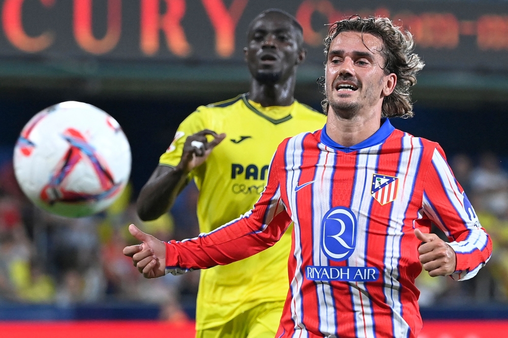 Eric Bailly and Atletico Madrid's French forward 07 Antoine Griezmann (R) vie for the ball during the Spanish league football match between Villarreal CF and Club Atletico de Madrid at La Ceramica stadium in Vila-real on August 19, 2024. 