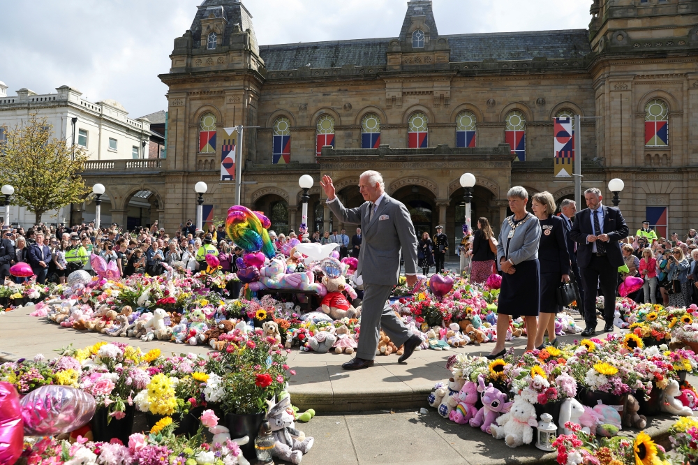 Britain's King Charles gestures, as he makes a community visit, outside the Town Hall in Southport, Britain. — Reuters 