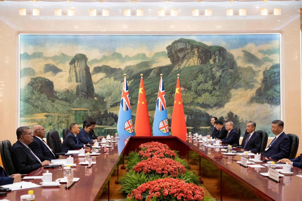 Fiji Prime Minister Sitiveni Rabuka (2nd L) and Chinese President Xi Jinping (R) attend a meeting at the Great Hall of the People in Beijing. — AFP 