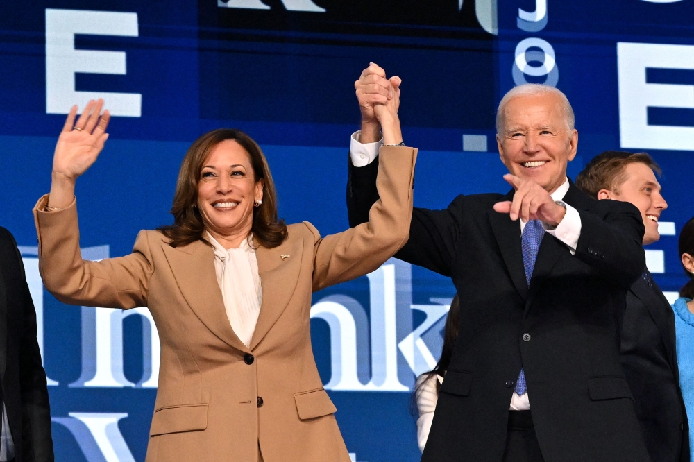 US President Joe Biden holds Vice President and 2024 Democratic presidential candidate Kamala Harris at the United Center in Chicago, Illinois, on Monday night. - AFP
