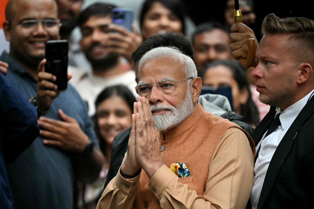 Indian Prime Minister Narendra Modi gestures as he arrives in Warsaw, Poland on August 21, 2024.  India's Narendra Modi launched on August 21 his historic trip to Poland and Ukraine, where the premier has pledged to campaign for a peaceful resolution of Russia's invasion of Ukraine. (Photo by Sergei GAPON / AFP)
