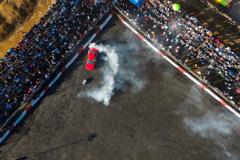 An aerial view of spectators watching a car drifting during a round of spinning at Wheelz n Smoke Arena in the south of Johannesburg