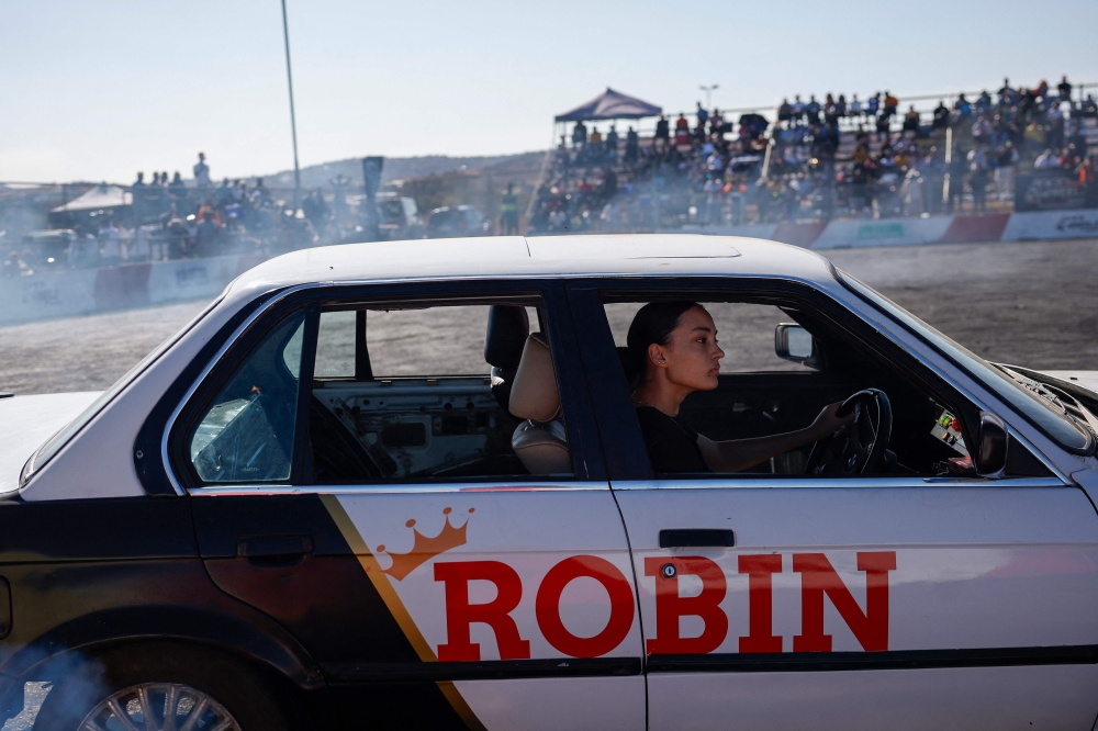 A car drifter 'Robin' spins her car during a round of spinning at Wheelz n Smoke Arena in the south of Johannesburg 