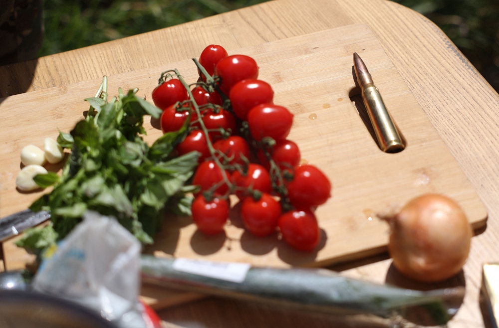 Ingredients for cooking pasta displayed near a bullet by Ukrainian serviceman and influencer Ruslan Mokrytskyi in the Donetsk region 