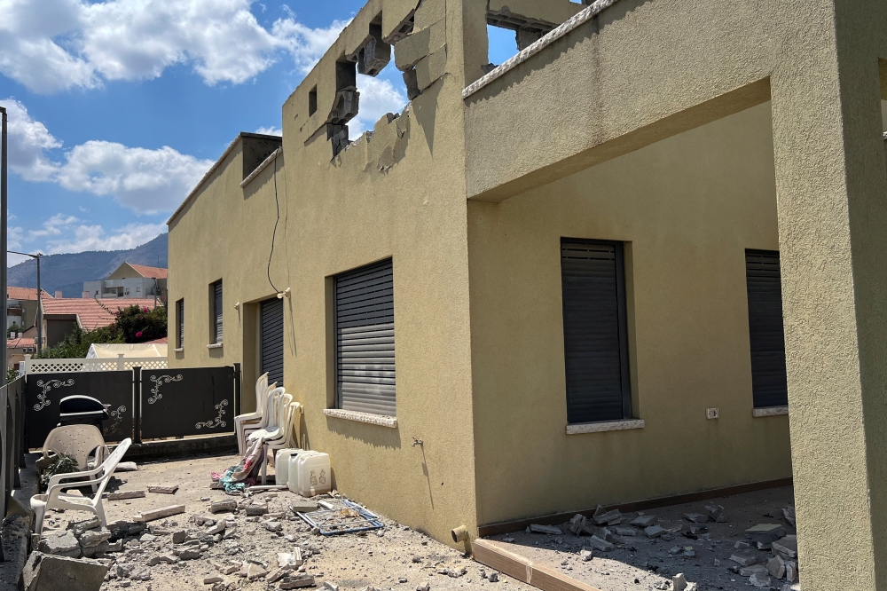 A view shows damage to a residential building after Hezbollah fired a barrage of projectiles 