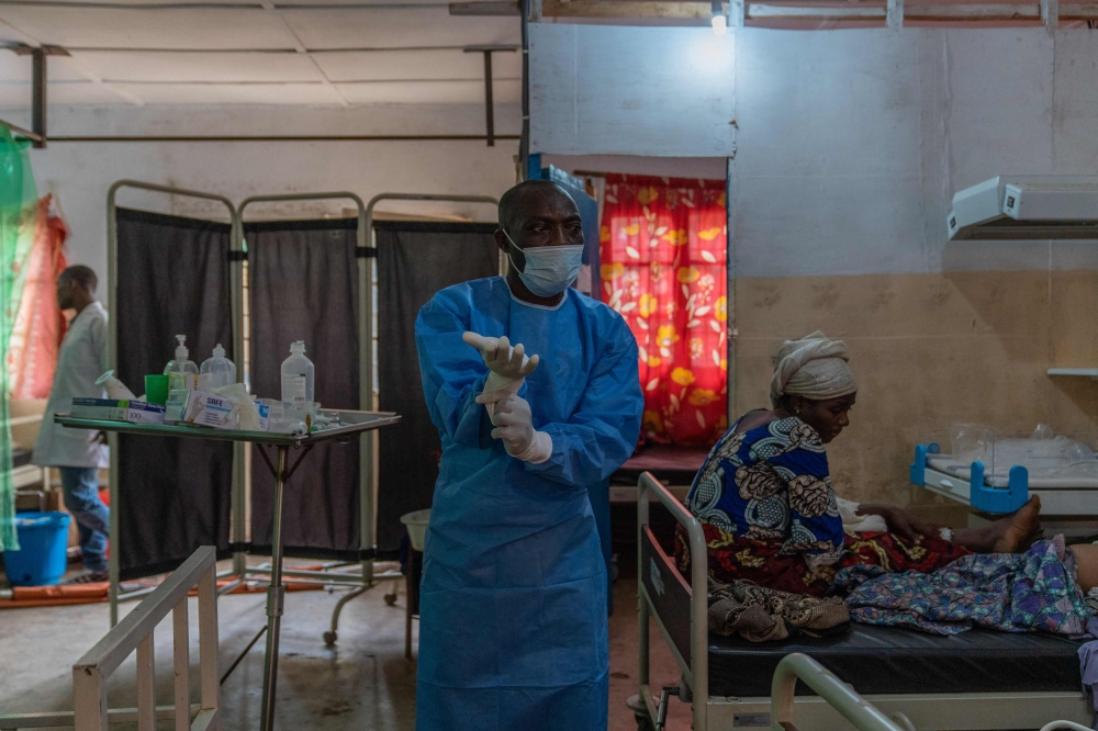 A nurse adjusts his gloves in a mpox ward at the Kavumu hospital, 30 km north of Bukavu in eastern Democratic Republic of Congo. - AFP